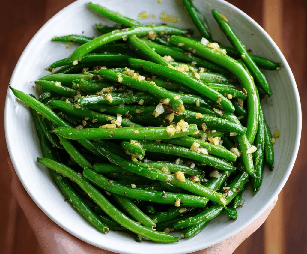 Fresh green beans tossed in garlic butter, garnished with herbs for a flavorful side dish