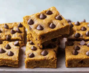 Delicious homemade pumpkin chocolate chip bars with a golden crust and gooey chocolate chips on top, perfect for fall desserts