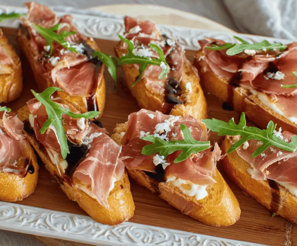 Delicious Brie and Prosciutto Crostini served on a rustic platter for appetizer.