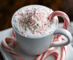 Creamy peppermint white hot chocolate topped with whipped cream and crushed peppermint candies.
