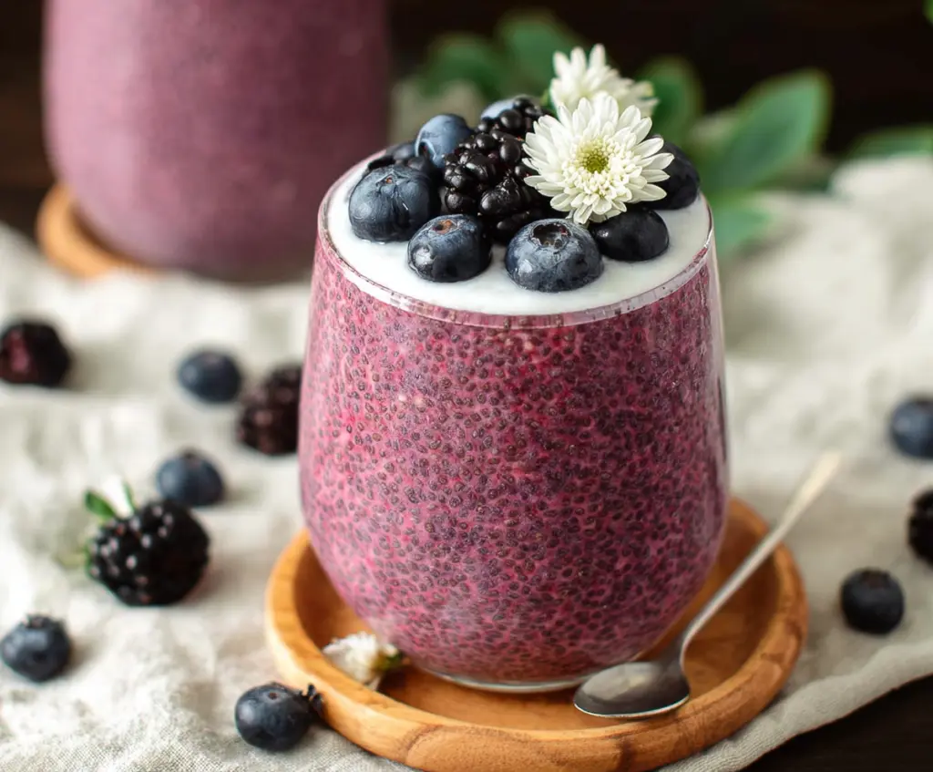 DeliciousBerryChiaSeedPudding topped with fresh berries and mint for a healthy breakfast