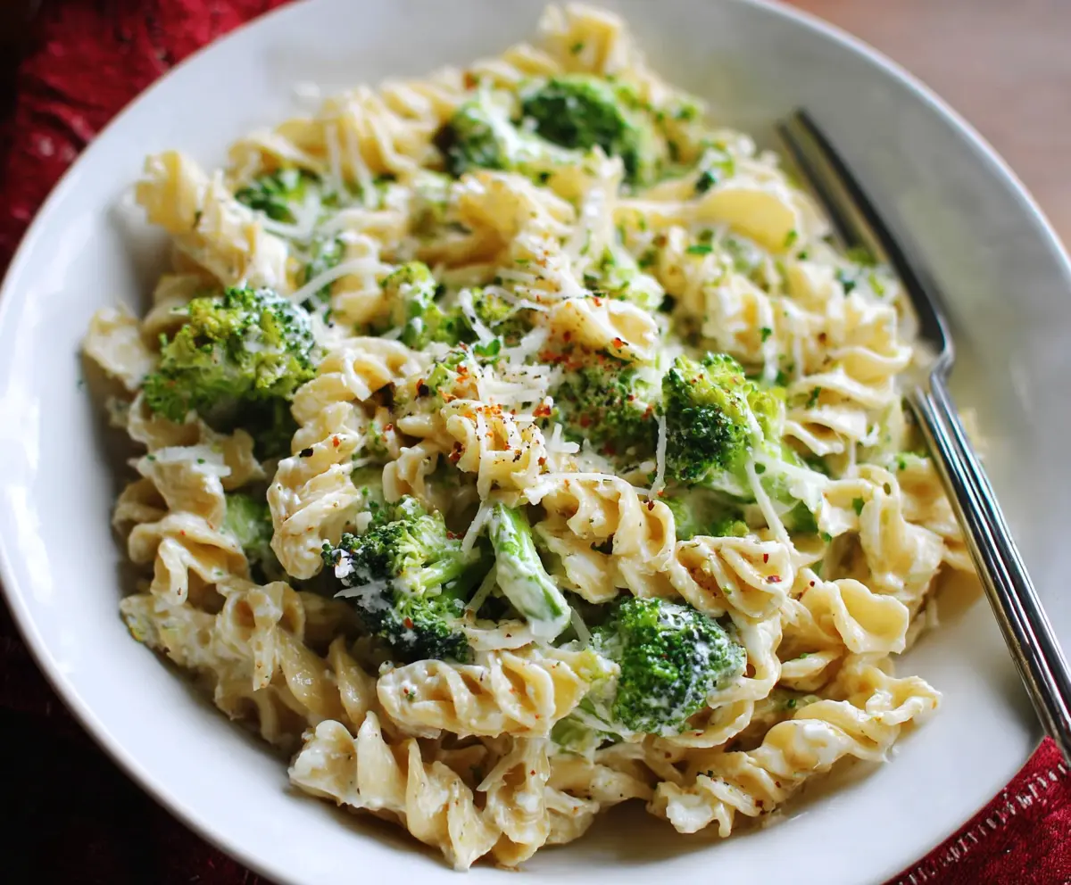 Creamy Boursin cheese pasta with fresh broccoli florets served on a plate.