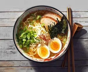 Delicious steaming bowl of Japanese Ramen Noodles with rich broth and toppings
