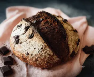 Delicious homemade chocolate sourdough discard bread on a rustic cutting board.