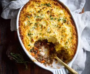 Delicious gluten-free shepherd's pie topped with mashed potatoes and seasoned ground meat.