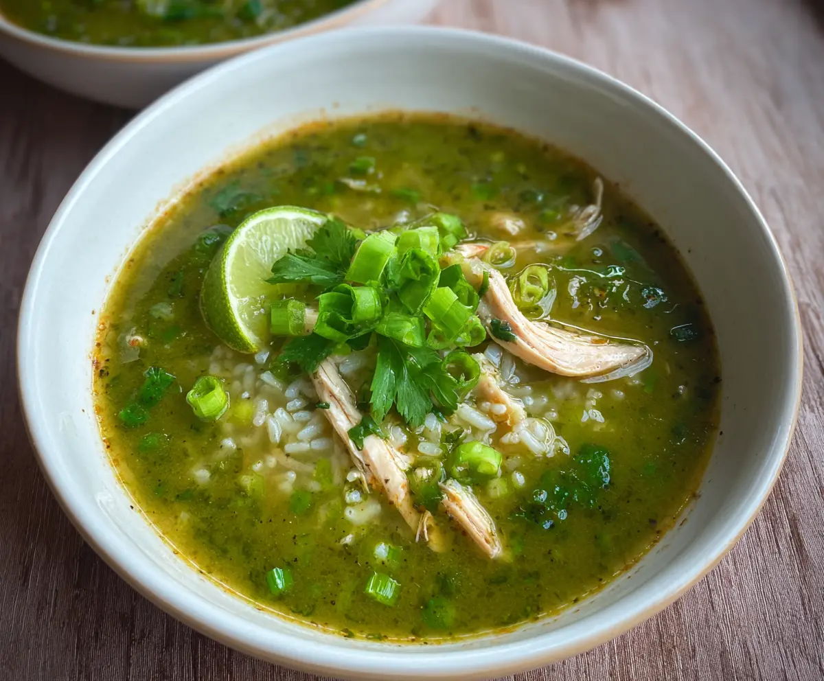 Delicious green garlic and ginger chicken and rice soup in a bowl, showcasing fresh ingredients and vibrant flavors.