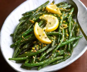 Fresh lemon green beans dish garnished with lemon slices and herbs, perfect for healthy eating.