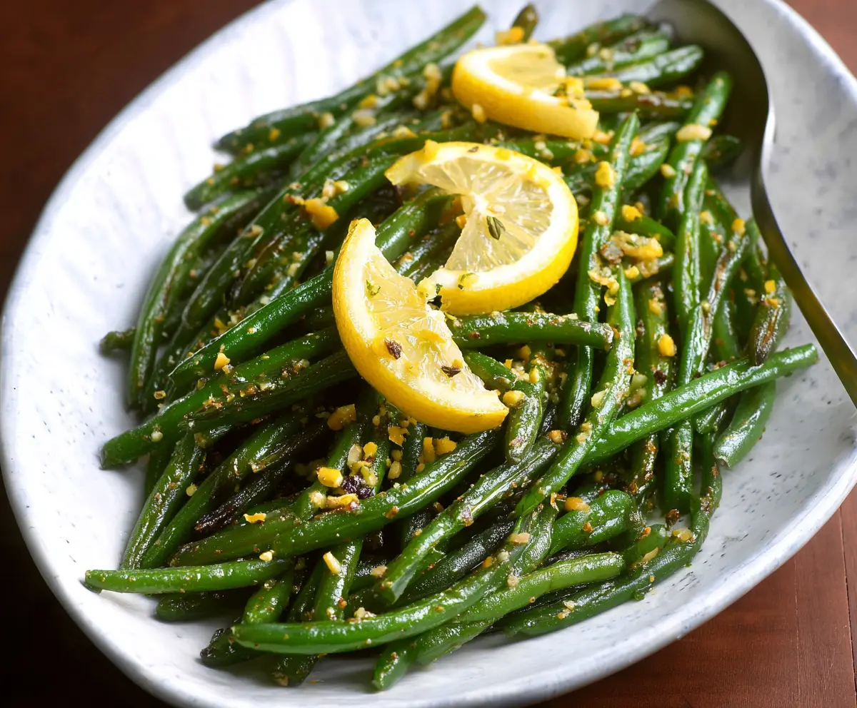 Fresh lemon green beans dish garnished with lemon slices and herbs, perfect for healthy eating.