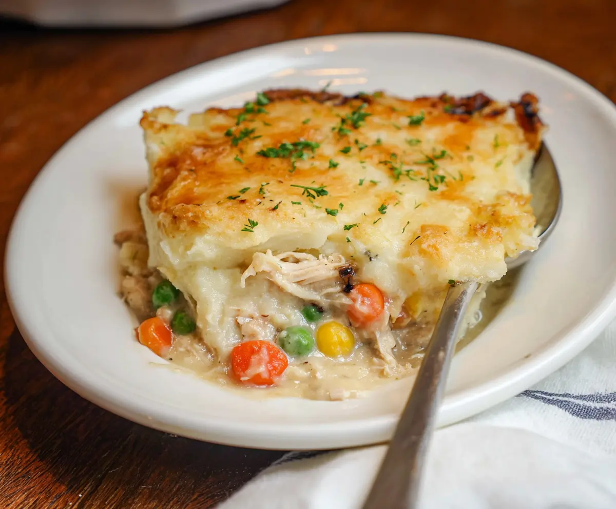 Delicious rotisserie chicken shepherd's pie topped with mashed potatoes and crispy golden crust.