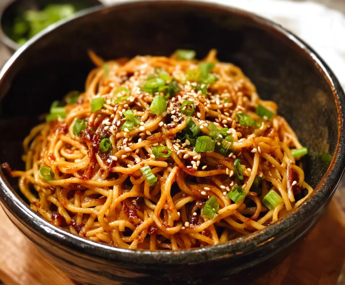 Delicious sesame garlic noodles served in a bowl with garnishes