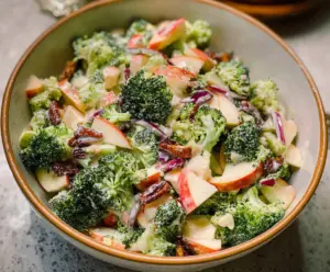 Fresh broccoli and crisp apple salad in a bowl, perfect for healthy eating.