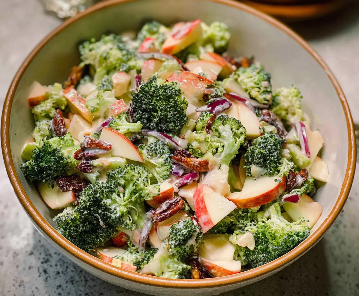 Fresh broccoli and crisp apple salad in a bowl, perfect for healthy eating.