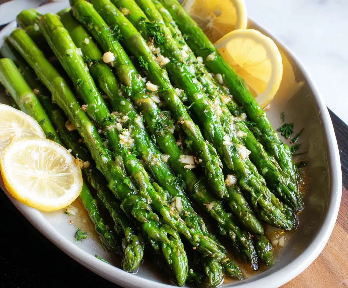 Fresh lemon garlic asparagus cooked to perfection, showcasing vibrant green spears with a hint of lemon and garlic flavor.