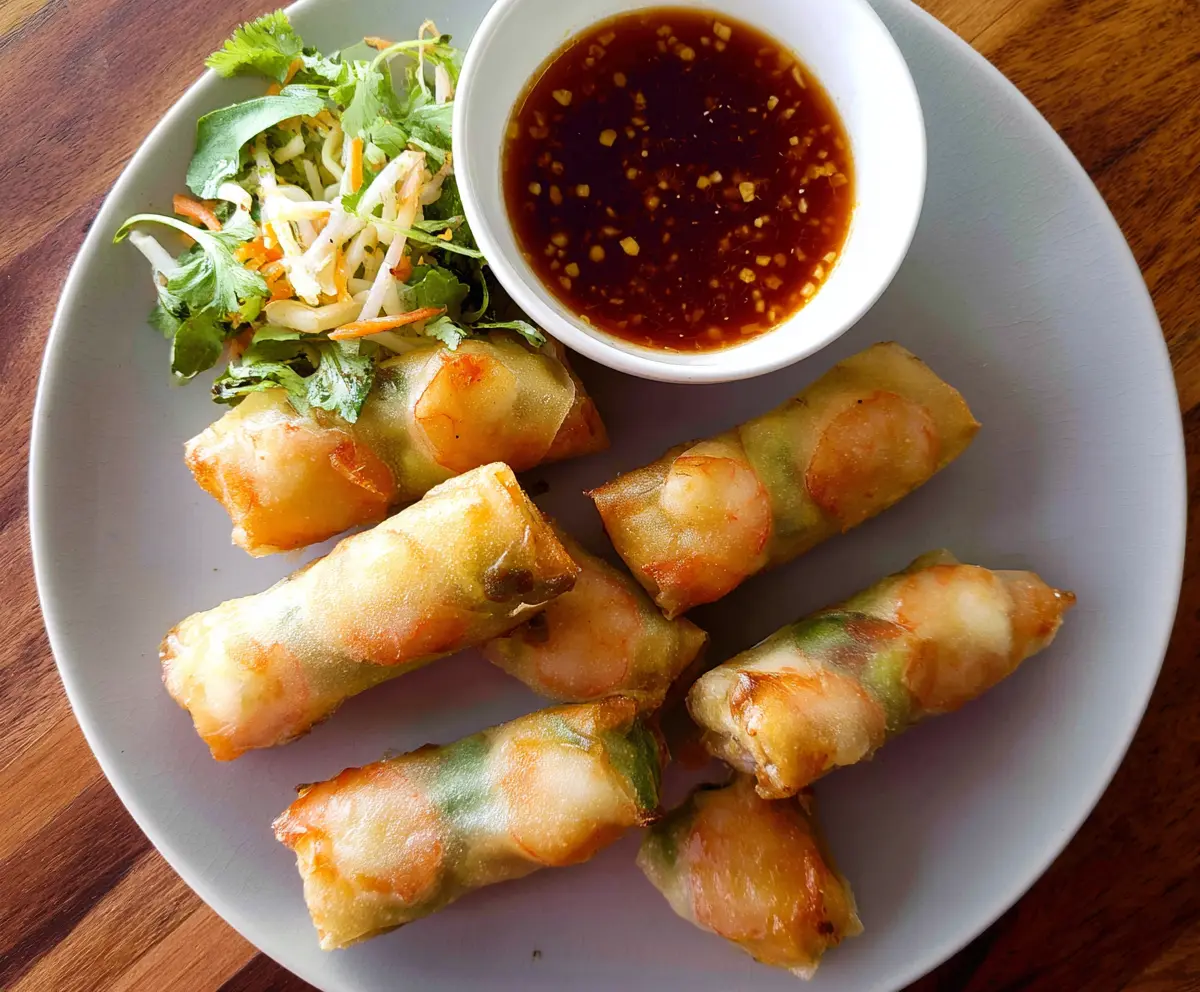 Fresh shrimp and pork spring rolls with vibrant vegetables and rice paper for a delicious appetizer.